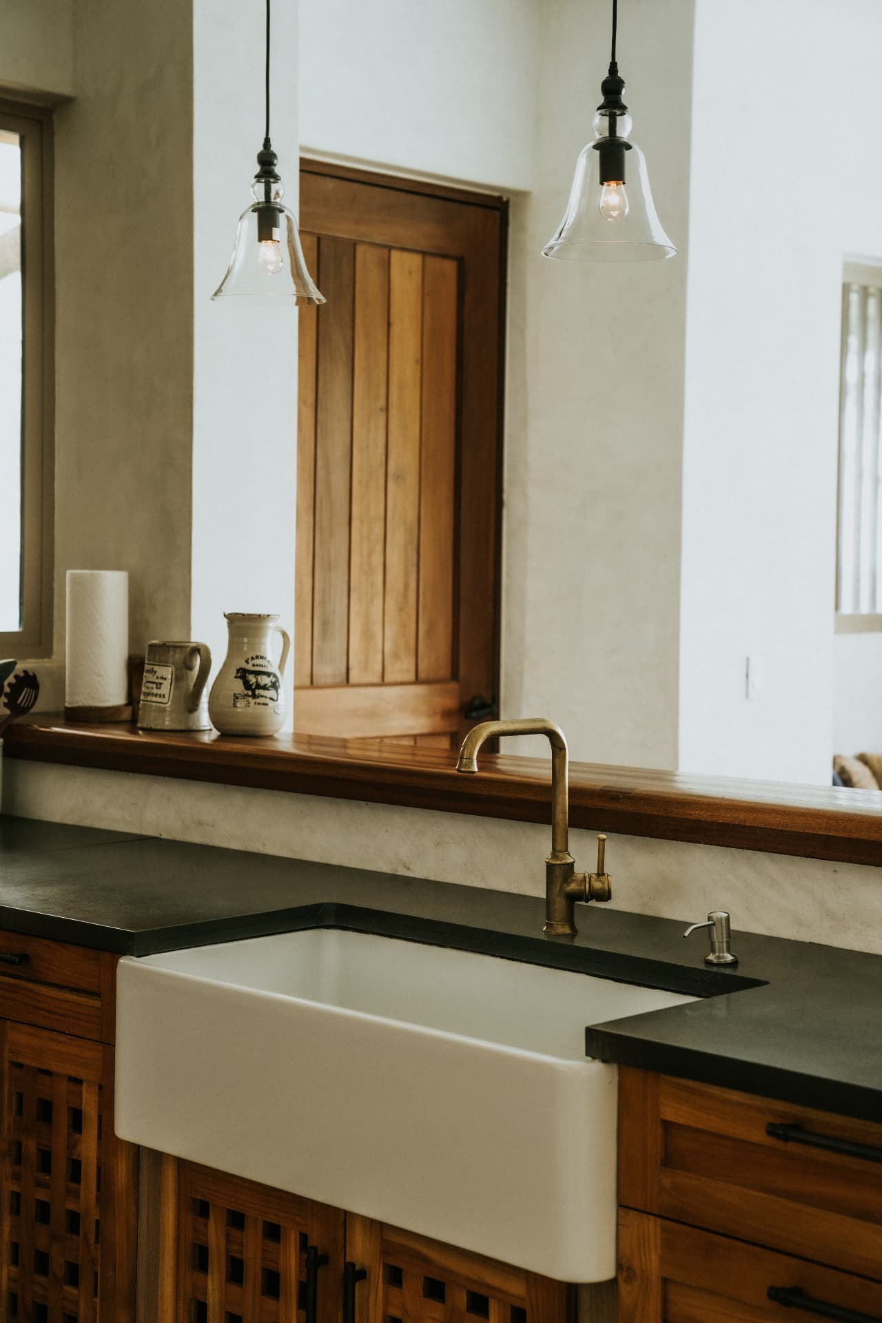 Villa Nomada — farmhouse sink with brass tap and pass-through window