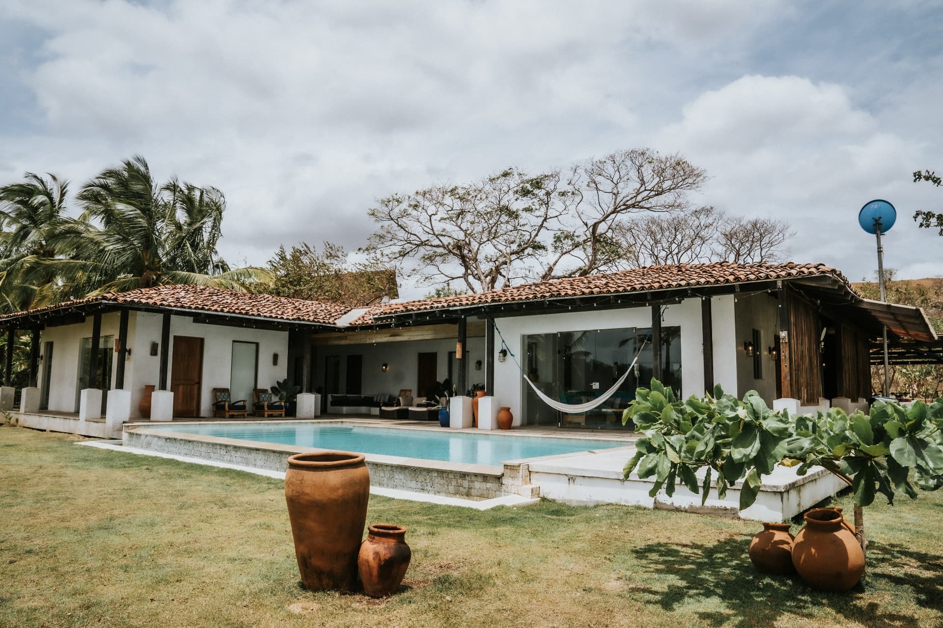 Villa Nomada — single-storey villa with terracotta roof, pool and tropical garden