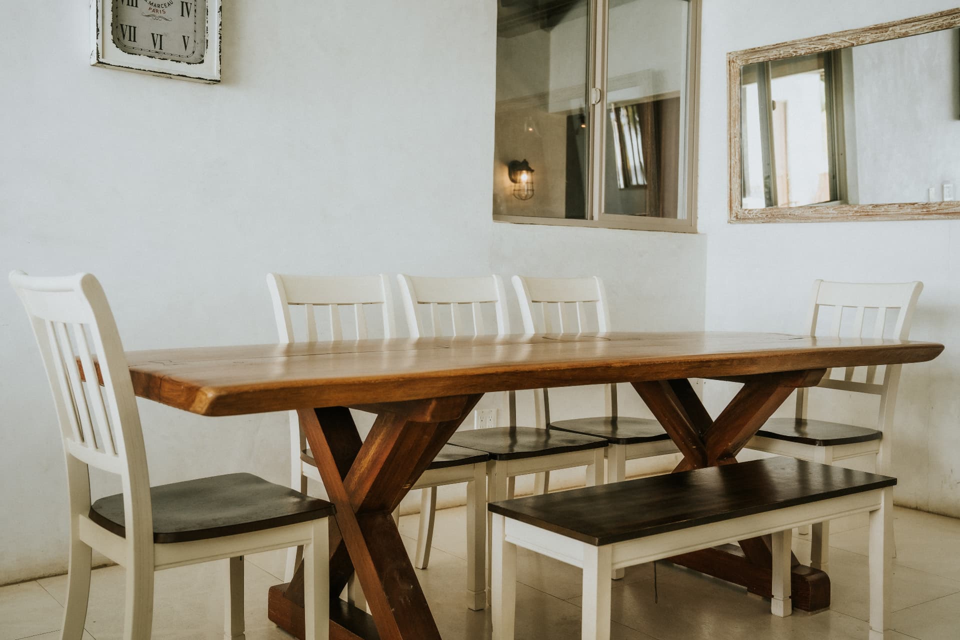 Villa Nomada — long wooden dining table with bench and white chairs