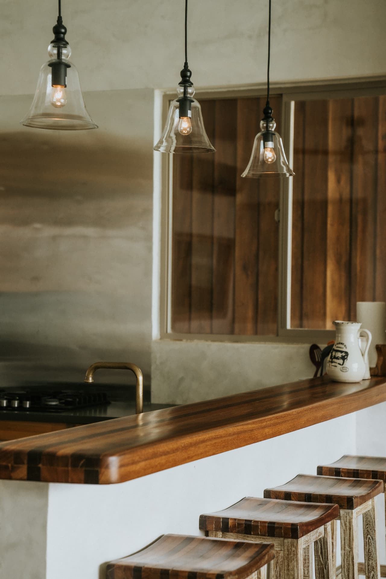 Villa Nomada — glass pendant lights above the wooden breakfast bar