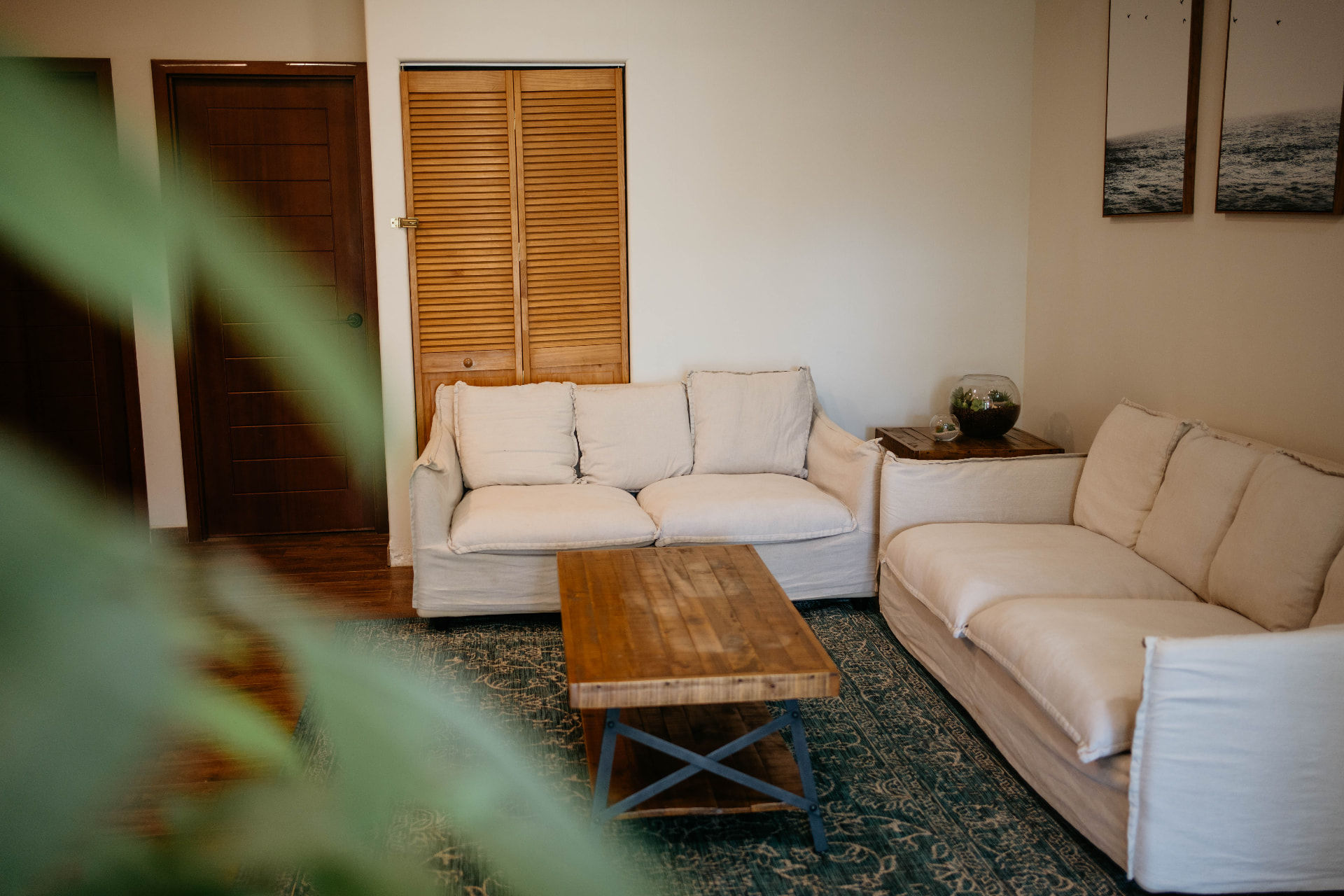 Apartment A18 — living room with two linen sofas and a wooden coffee table