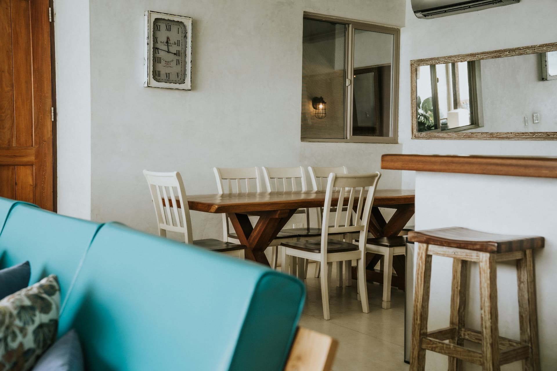 Villa Nomada — dining table and chairs beside the living room sofa