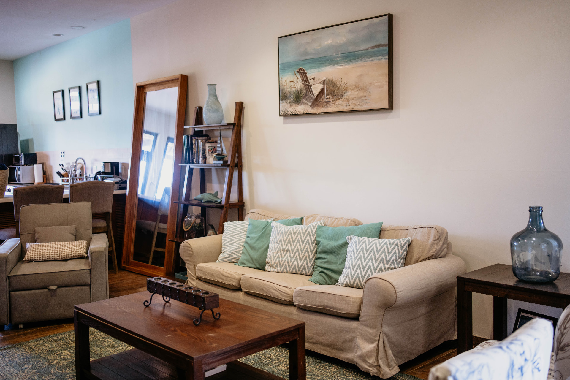 Apartment B21 — living room with linen sofas, mirror and shelving